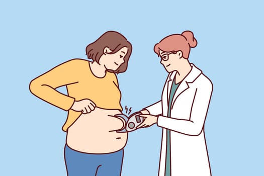Woman nutritionist measures size of fat layer in overweight patient to give recommendations on dietary. Girl visits nutritionist or plastic surgery clinic and wants to do liposuction to become slim