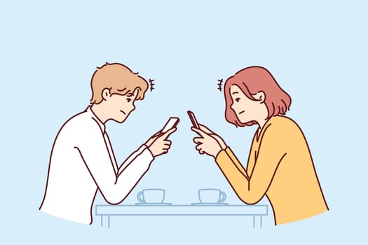 Couple with phones sits in cafe, addiction to social networks and internet chatting, not paying attention to interlocutor. Concept of social problems associated with digital addiction to gadgets