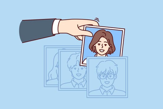 Hand of recruiter making selection of employees for company assembling team in HR division corporation. Person is engaged in recruitment, working as HR manager and finding people for current vacancies
