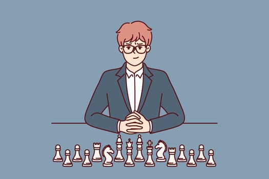 Businessman with chess pieces sits at table and looks at screen for concept of strategic planning in business. Man ceo of large corporation near chess symbolizing mind and strategic thinking