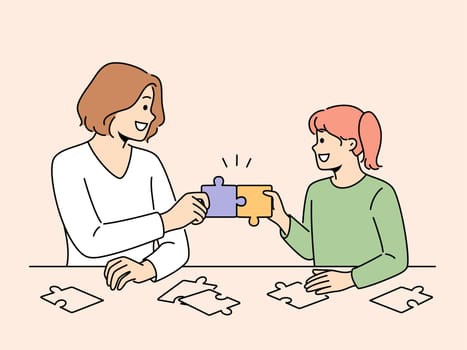 Smiling mother and daughter solve puzzles together. Happy mom and girl child connect jigsaw pieces engaged in funny game sitting at table. Vector illustration.
