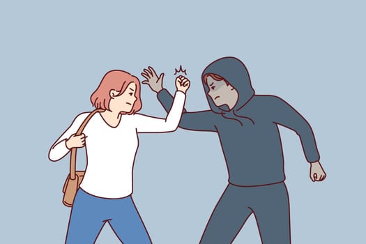 Strong woman fights back against thief by showing self-defense techniques to man who tried to steal purse and commit crime. Self-defense and martial art concept of krav maga against street thug
