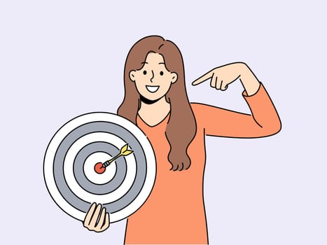 Smiling woman point at shooting target