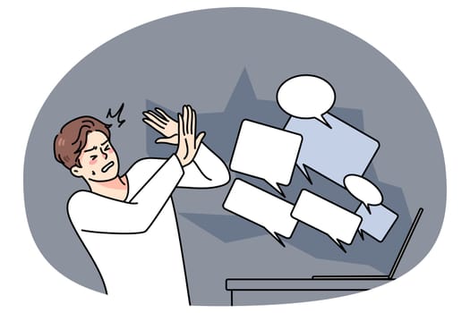 Stressed man overwhelmed with online negative comments and messages on computer. Unhappy guy struggle with hate and bullying on internet. Abuse on social media. Vector illustration.
