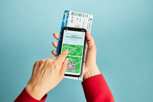 Digital covid certificate. Covid negative rapid digital test pass. Woman passenger holding digital medical pass on her mobile phone and airplane ticket. Traveler showing digital covid test result as medical pass for travel during covid-19 pandemic
