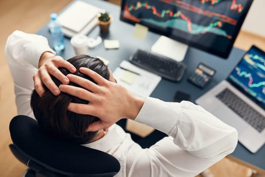 Worried businessman looking at charts stressed by news from stock market. Investor lost money online. Man analyses loss and profit. Businessman investing stocks online. Man working with stock chart data. Business investing trouble concept