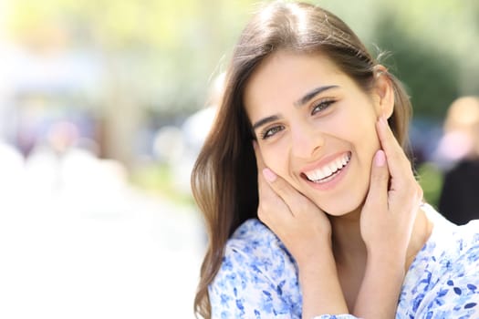 Beauty woman with perfect smile looking at camera in the street