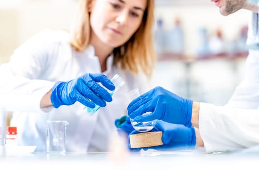 scientists conduct biochemical research in a scientific laboratory. Invent a new drug and substance. High quality photo