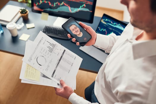 Businessman trading stocks online. Stock investor discussing numbers at graphs while video conversation with his colleague. Business team planning and analyzing stock market graphs. Man working with stock chart data. Business man investing stock using online platform. Business success concept