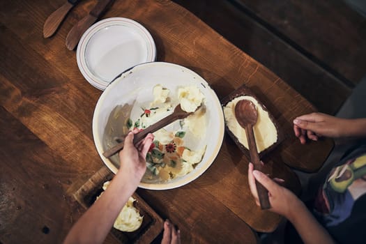 Female putting homemade butter to bowl. Old traditional method making of butter