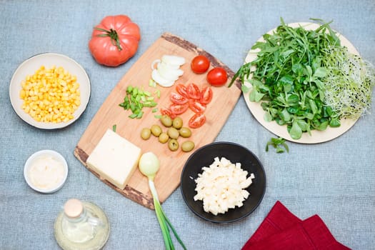 Preparing healthy snacks with fresh cheese and vegetables