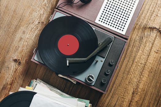 Listening to music from vinyl record. Playing music from analog disk on turntable player. Enjoying music from old collection. Relaxing at home. Retro and vintage. Audio stereo equipment. Analog sound