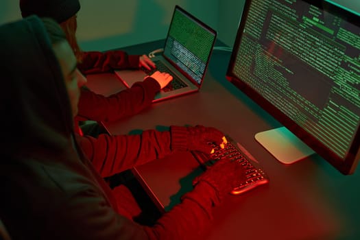 Anonymous people using computer and programming to break code. Cyber security threat. Internet and network security. Access to private information. Anonymous hackers using technology to access to password and encrypted data. Cyber attack