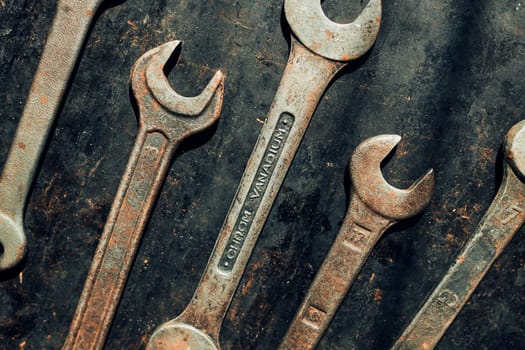 Spanners on steel surface. Old rusty wrenches for maintenance. Mechanic hardware tools to fix. Technical tools background with copy space