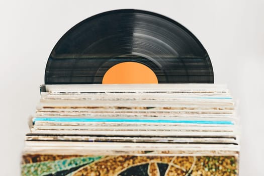 Stack of vinyl records. Listening to music from record. Playing music from analog disc. Retro music party. Vintage style. Analog equipment. Stereo sound. Back to the past