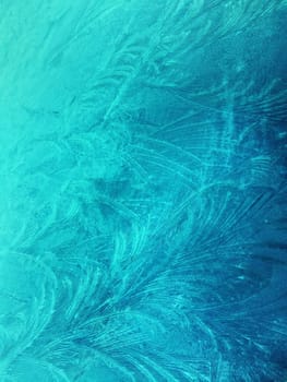 Frozen glass, ice flowers, winter background, abstract texture