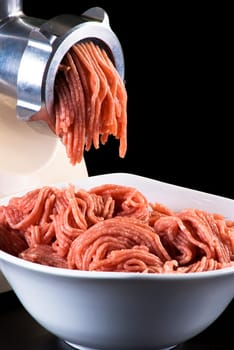 Bowl of mince with electric meat grinder