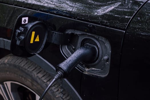 Electric cable plugged in for charging a hybrid vehicle