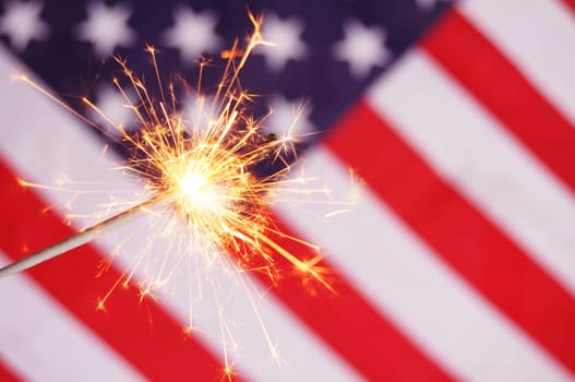 sparkler and usa flag showing 4th of july
