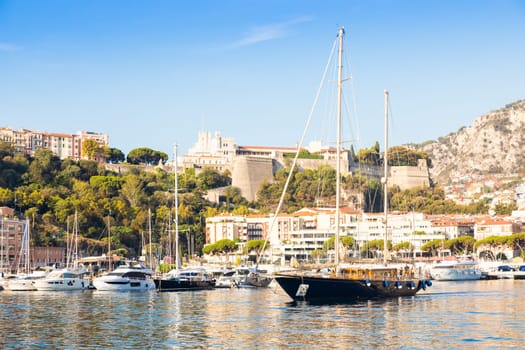 Monte Carlo, Monaco - August 2022: Port Hercule with luxury yachts,  boats, and scenery skyline