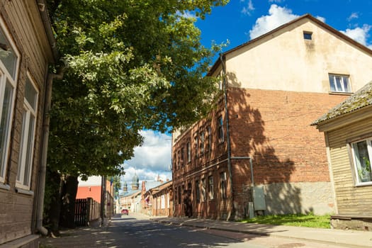 Jekabpils old town street in Latvia. In the distance, the domes of the men's monastery.