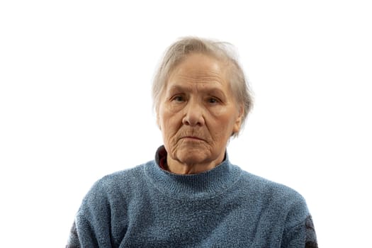 Portrait of an old serious woman on a white background