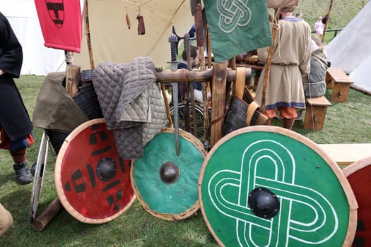 Medieval weapons, shields in knight camp at the festival of historical reconstruction