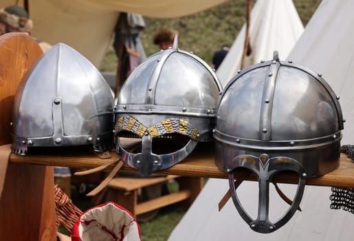 Medieval weapons, helmets in knight camp at the festival of historical reconstruction