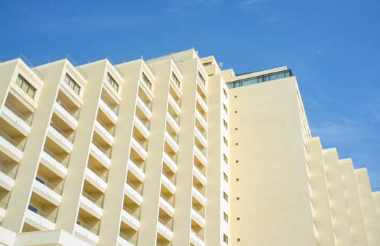 Clear block of flats over blue sky. Seventies beachfront architecture