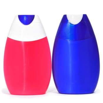 a pair of toothpaste bottles on a white background