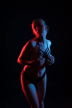 Topless sensual caucasian woman. On a black background.