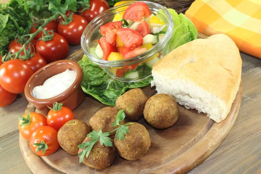 Falafel with fresh salad against a bright background