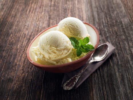 Vanilla Ice cream on a wooden background close up