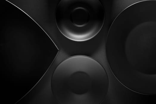 Top view of black empty plates on dark grey background.