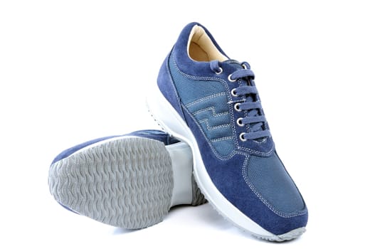 Sports shoes for adult man photographed on white background.