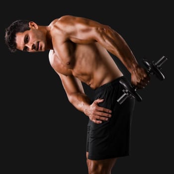 Portrait of a muscular man practicing body combat against a dark background