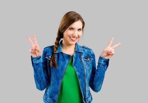 Portrait of a beautiful woman smiling over a grey background