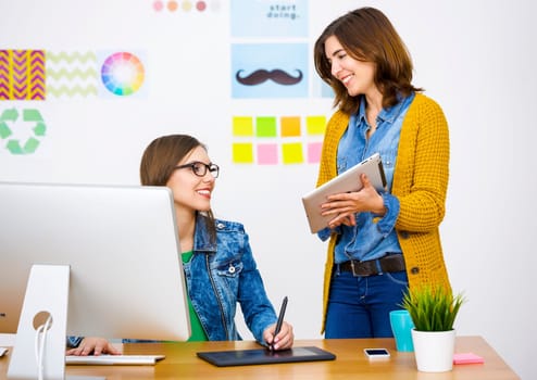 Women working at desk In a creative office, team work