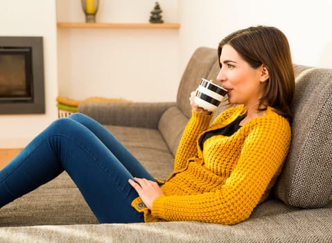 Beautiful woman at home Having a good time with cup a coffee
