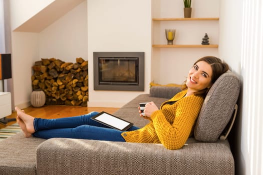 Beautiful woman working from the confort of home with her laptop