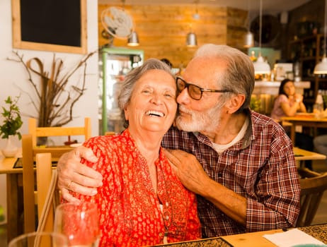 Old couple at the restaurant and  having a good time