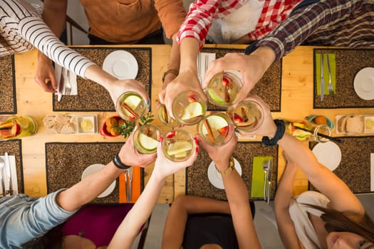 Group of people toasting and looking happy at a restaurant