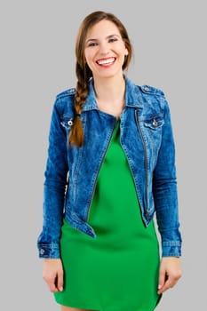 Portrait of a beautiful woman smiling over a grey background