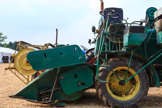 Agriculture, old grain thresher, agricultural tractor