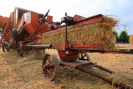 Close up of an old agricultural vehicle for packing straw, rural life
