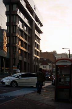 London,United Kingdom – November 29,2014: Road traffic and pedestrians outside the Royal Bank of Scotland building during a sunset on 29 November 2014 in London.