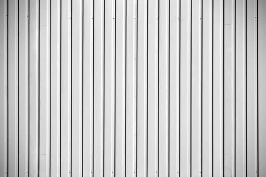 The close-up of the fluted metal wall of a construction container.