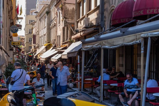 Istanbul, Turkey - July 31, 2022. Citizens walking in a typical commercial street. Istanbul, Turkey.