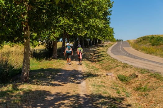 Navarre, Spain, 26 August, 2022: Pilgrims walk along the Camino De Santiago, the Way of St. James pilgrimage route, Navarra, Spain.