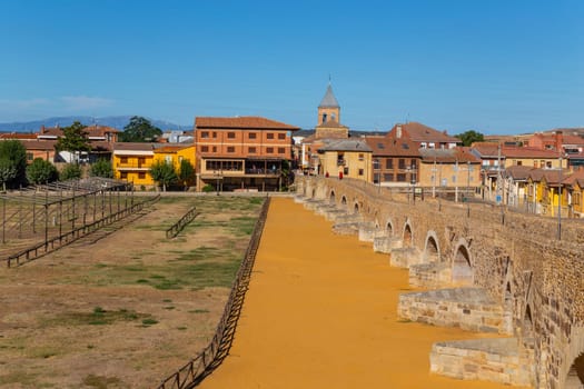 Hospital de Orbigo, Spain - August 18, 2022 - Some pilgrims walking along the way of St.James, in Hospital de Orbigo